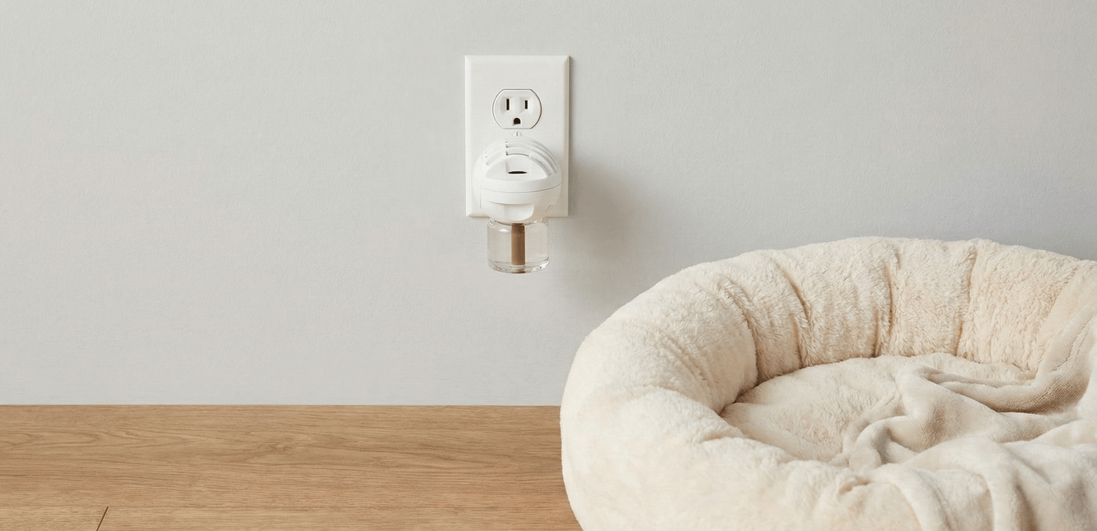 A plug-in pheromone diffuser near a cozy pet bed