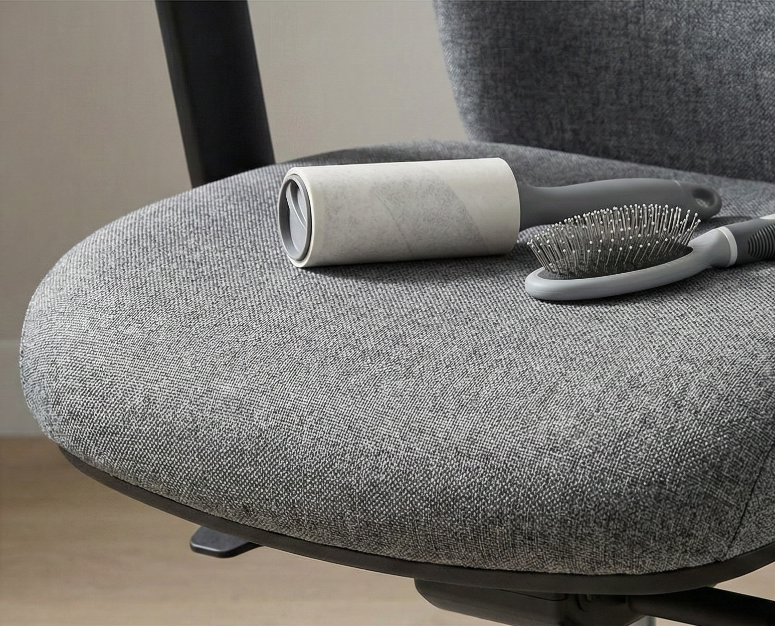 Close up of durable chair fabric with a lint roller and pet brush
